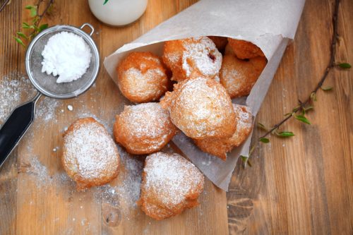 Doughnuts Beignet with sugar powder and jam on the wooden table