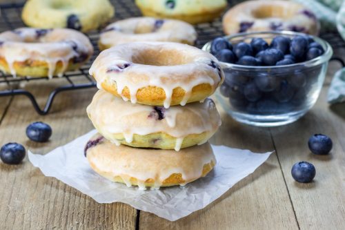 Freshly baked baked doughnuts with blueberries and lemon glaze