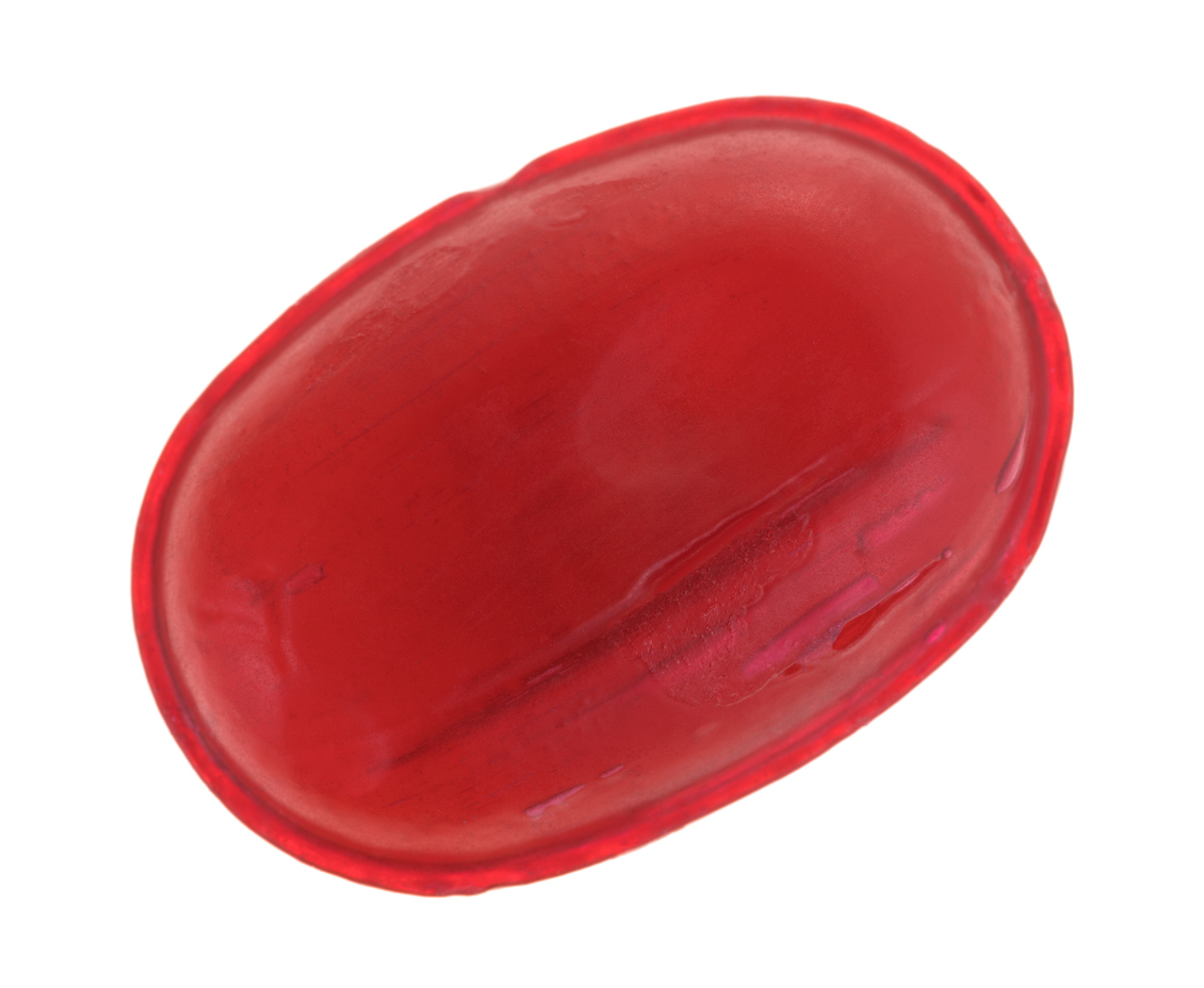 Close up of a red cough drop.