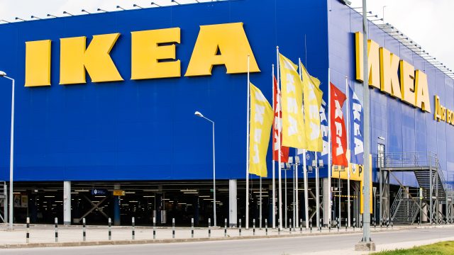 The exterior of an IKEA store with flags blowing in the wind