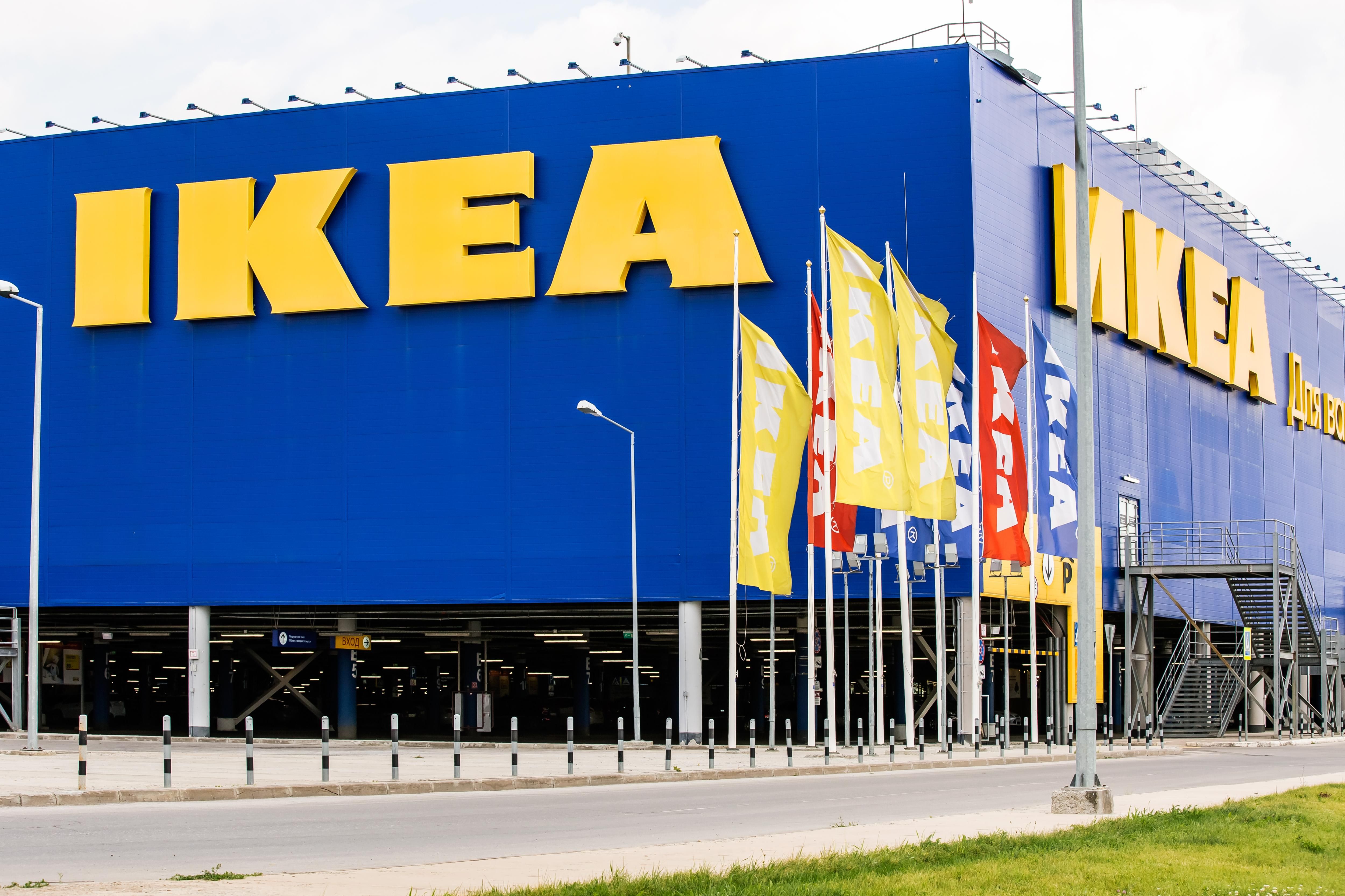 The exterior of an IKEA store, with flags fluttering in the wind