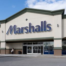 The exterior of a Marshalls store with a stop sign in the picture.
