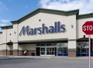 The exterior of a Marshalls store with a stop sign in the picture.