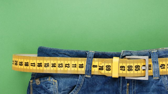 Jeans,With,Meter,Belt,Slimming,On,The,Green,Background