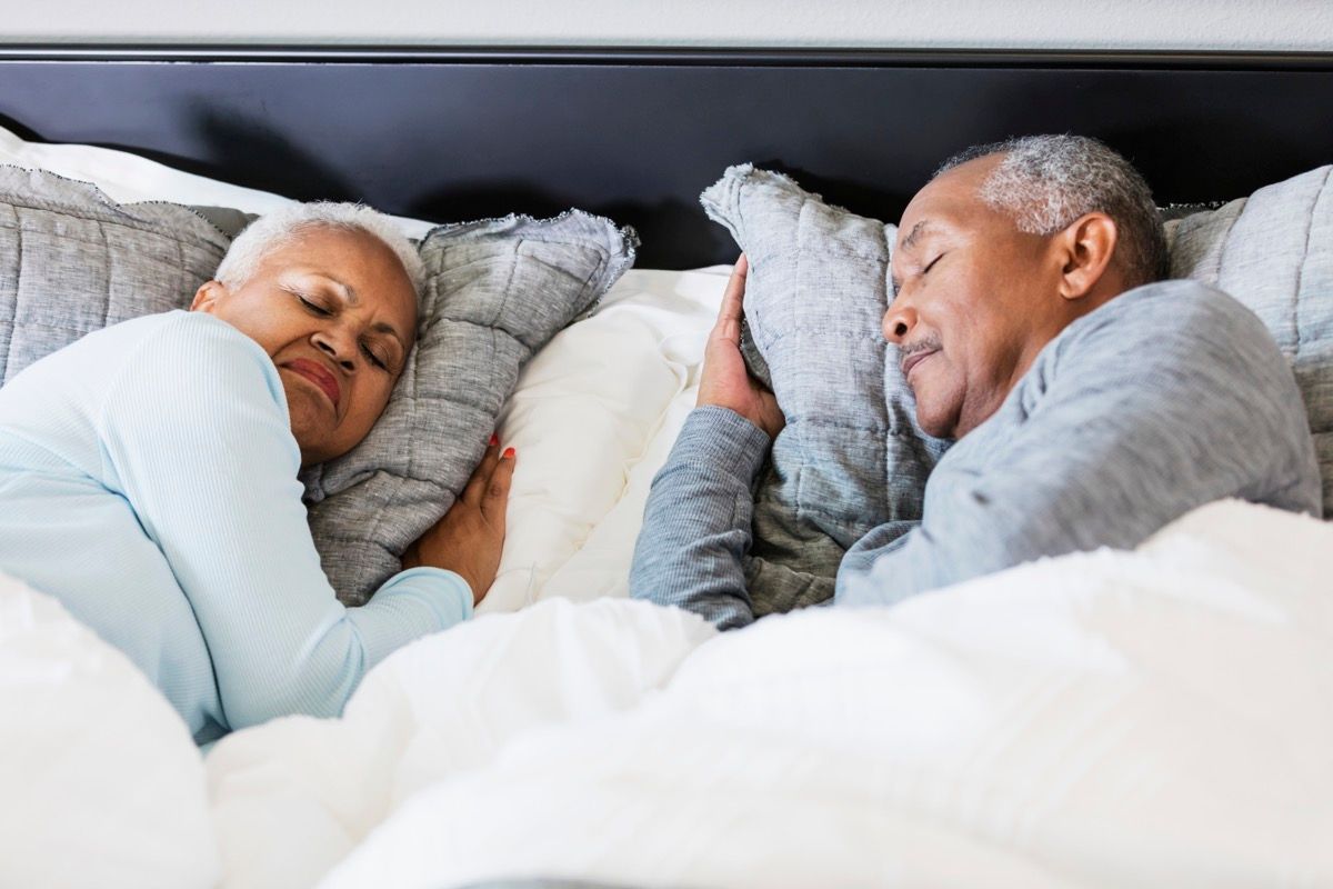 couple sleeping in bed. It is morning, time to get up soon.