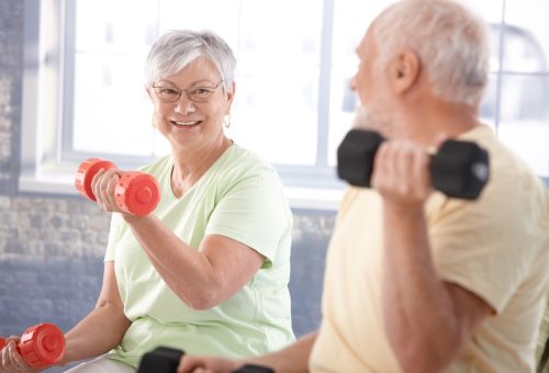 Vital senior couple exercising in the gym.