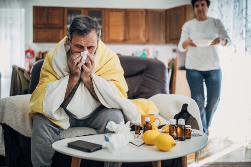 A sick man from a virus is at home