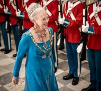 Queen Margrethe of Denmark reviews an honour guard as she arrives to the gala banquet at Christiansborg Palace