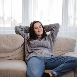 woman leaning back on the couch alone