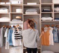 woman looking at organized closet