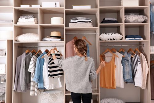 woman looking at organized closet