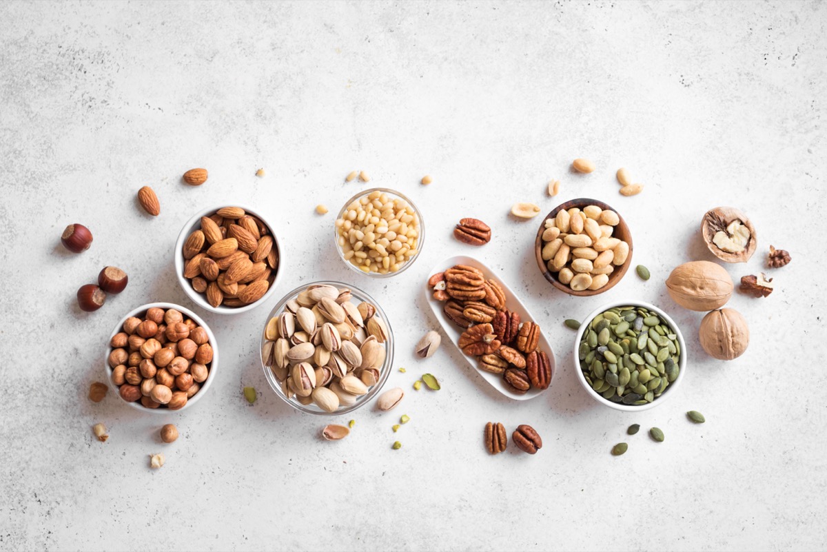 Nuts and Seeds in small bowls on a gray background
