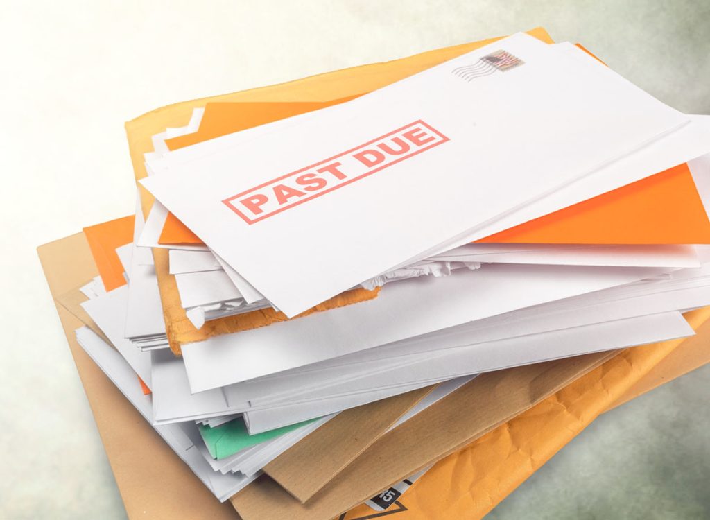 A pile of envelopes and mail with "past due" stamped on them
