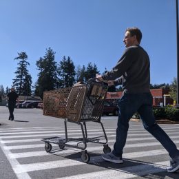 man leaving the grocery store