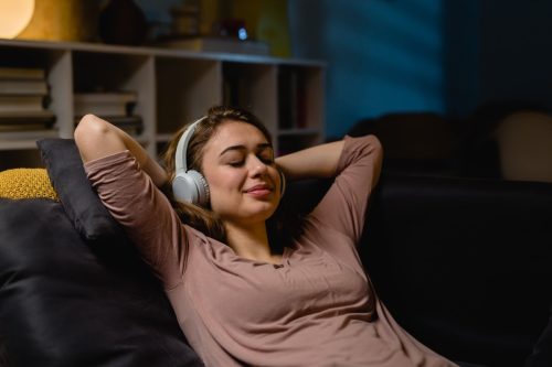 Person Laid Back With Headphones on