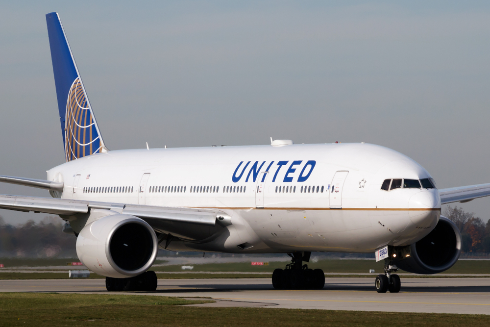 A United Airlines airplane taxiing on a runway at an airport