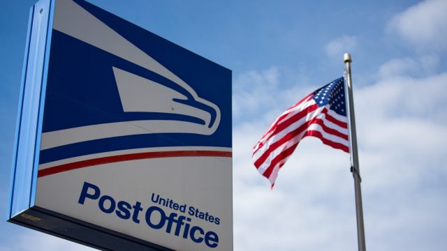 usps post office sign with American flag