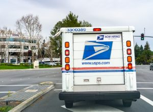 USPS vehicle driving on a busy street in south San Francisco bay area