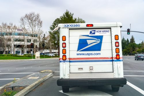 USPS vehicle driving on a busy street in south San Francisco bay area