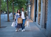 Couple embraced while shopping in a commercial street in the evening