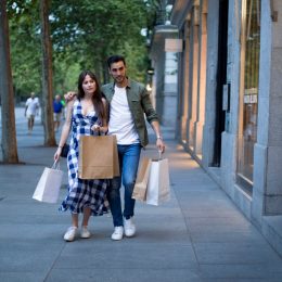 Couple embraced while shopping in a commercial street in the evening