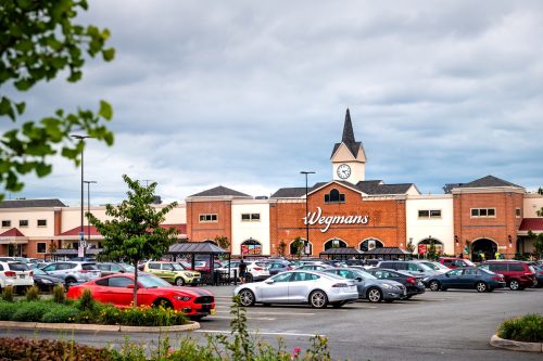 Wegmans grocery store by parking lot with tower architecture and many cars in northern Virginia