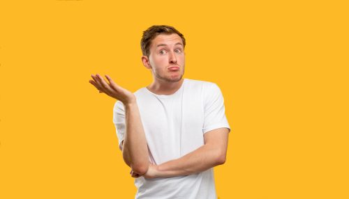 man looking clueless with hand in air