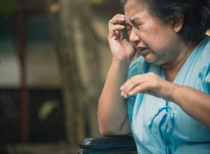 Asian elder woman suffer from stroke and powerful headache or brain attack.