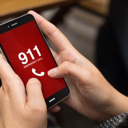 Hands on phone calling 911.
