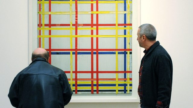 Two men inspect the painting "New York C
