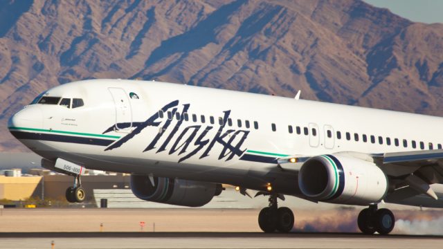 An Alaska Airlines plane landing at an airport