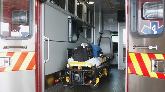 Paramedic's truck with open back doors, where stretcher and medical equipment is visible.