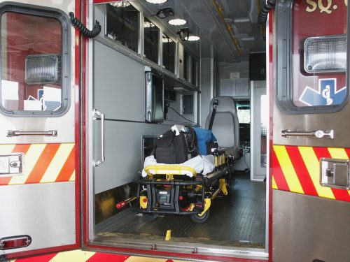 Paramedic's truck with open back doors, where stretcher and medical equipment is visible.