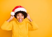 woman in santa hat sharing laughing at christmas puns