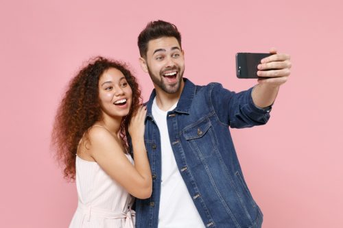 couple taking a selfie to post to instagram