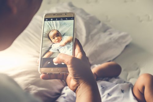 woman taking instagram photo of her baby
