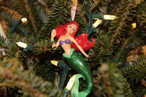Disney ornament hanging on a Christmas tree