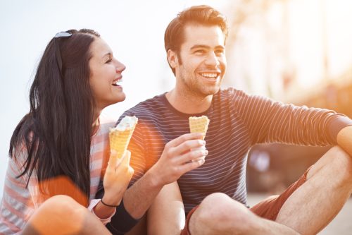 man and woman eating ice cream cones