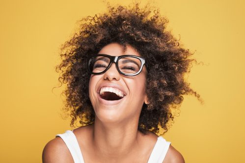 woman in glasses laughing