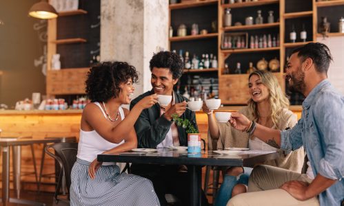 group of young adults drinking coffee and sharing good morning messages for friends