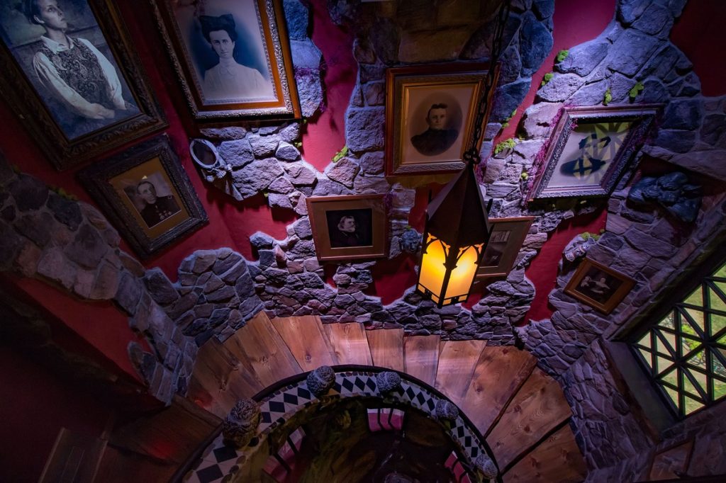 A staircase decorated like a haunted castle with ghostly pictures