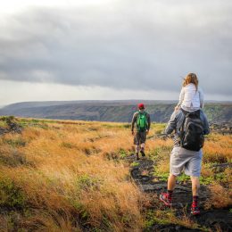 A family of three hiking in Hawaii Volcanoes National Park