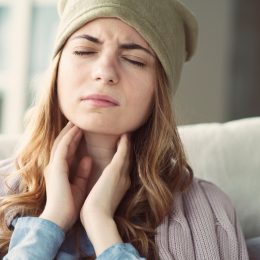 Woman suffering from a sore throat.