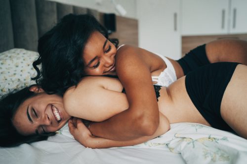 young lesbian couple in the bed