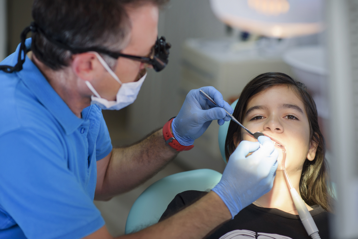 Dentist examining patient.