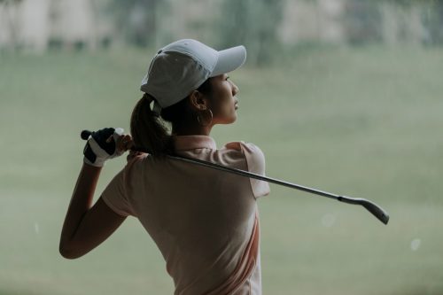 young asian woman playing golf