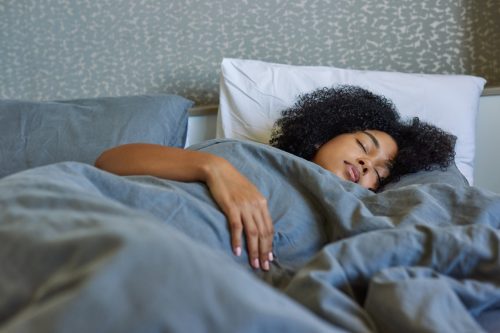 young black woman sleeping in bed