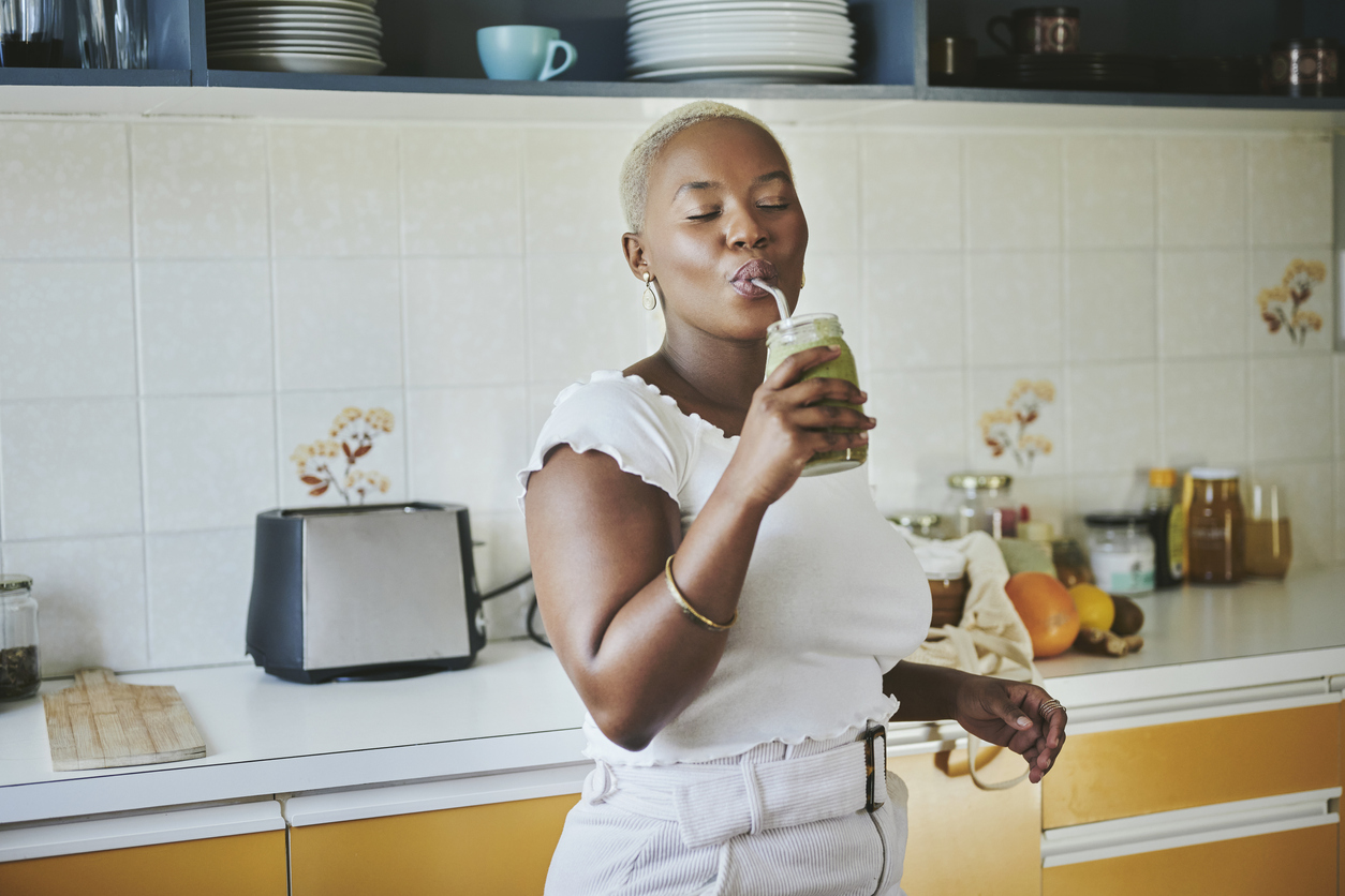 young black woman enjoying a smoothie