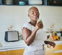 young black woman enjoying a smoothie