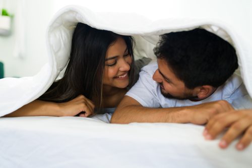 beautiful young couple in bed